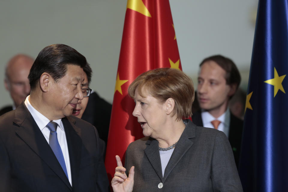 FILE - German Chancellor Angela Merkel, right, talks to Chinese President Xi Jinping during a signing ceremony of various contracts between Germany and China at the chancellery in Berlin, Germany, on March 28, 2014. Merkel has been credited with raising Germany’s profile and influence, helping hold a fractious European Union together, managing a string of crises and being a role model for women in a near-record tenure. Her designated successor, Olaf Scholz, is expected to take office Wednesday, Dec. 8, 2021. (AP Photo/Markus Schreiber, Pool, File)