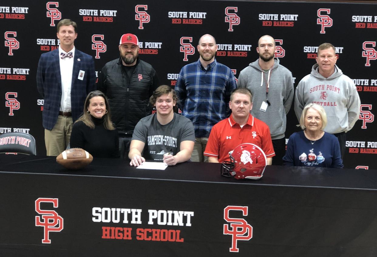 South Point's Johnny Armstrong (center) is all smiles after signing a National Letter of Intent to play football at Hampden-Sydney College in Virginia.