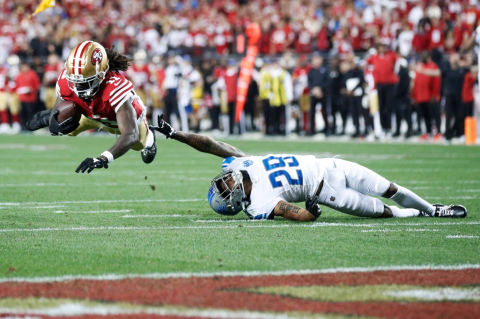 49ers wide receiver Brandon Aiyuk catches the ball over Lions cornerback Kindle Vildor in the third quarter of the NFC championship game at Levi's Stadium in Santa Clara, California, on Sunday, Jan. 28, 2024.