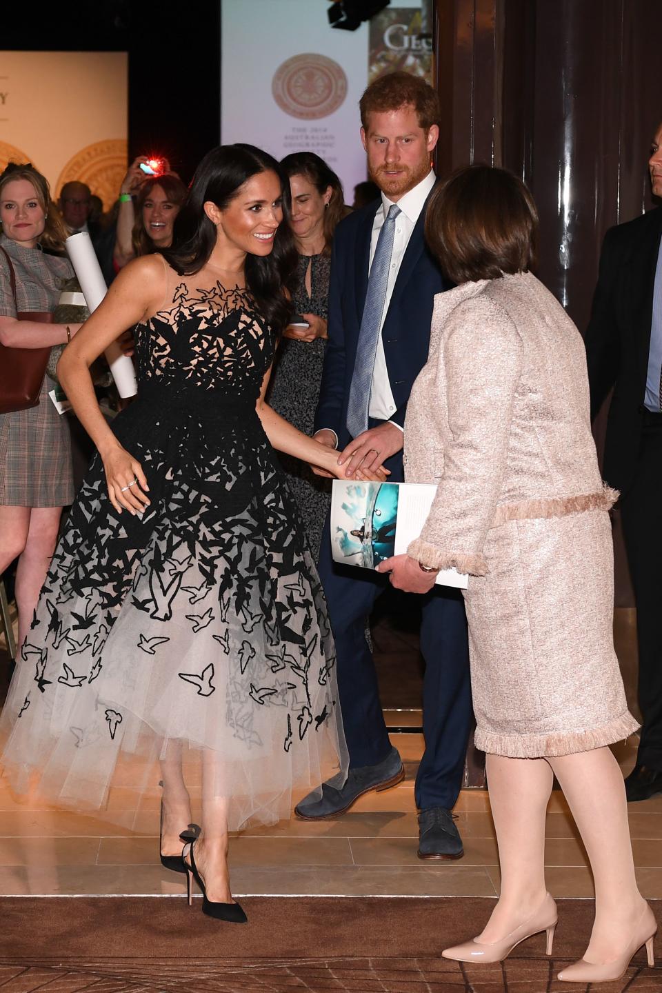 <p>The Duchess of Sussex saved her greatest look of the royal tour until October 26 for the Australian Geographic Society Gala Awards at the Shangri-La Hotel in Sydney. The cold-shoulder tulle gown is from Oscar de la Renta’s pre-AW18 collection and she finished the Hollywood-worthy look with soft waves and her go-to £571 Tabitha Simmons <a rel="nofollow noopener" href="https://www.bloomingdales.com/shop/product/tabitha-simmons-womens-millie-slingback-pointed-toe-pumps?ID=2956738&PartnerID=LINKSHARE&cm_mmc=LINKSHARE-_-n-_-n-_-n&ranMID=37205&ranEAID=QFGLnEolOWg&ranSiteID=QFGLnEolOWg-yliFTBxGUGXhLMh6WQXvLA&LinkshareID=QFGLnEolOWg-yliFTBxGUGXhLMh6WQXvLA&ranPublisherID=QFGLnEolOWg&ranLinkID=1&ranLinkTypeID=15&ranMID=37206&ranEAID=QFGLnEolOWg&ranSiteID=QFGLnEolOWg-1lSo8XAy.R9BM9f_ns7WdQ&LinkshareID=QFGLnEolOWg-1lSo8XAy.R9BM9f_ns7WdQ&ranPublisherID=QFGLnEolOWg&ranLinkID=1&ranLinkTypeID=15&ranMID=37206&ranEAID=TnL5HPStwNw&ranSiteID=TnL5HPStwNw-AQJP9WrM0jnj5oJSuHw3Cw&LinkshareID=TnL5HPStwNw-AQJP9WrM0jnj5oJSuHw3Cw&ranPublisherID=TnL5HPStwNw&ranLinkID=1&ranLinkTypeID=10&ranMID=37206&ranEAID=TnL5HPStwNw&ranSiteID=TnL5HPStwNw-Fy_vVPLnOqvB7pj62eZoxA&LinkshareID=TnL5HPStwNw-Fy_vVPLnOqvB7pj62eZoxA&ranPublisherID=TnL5HPStwNw&ranLinkID=1&ranLinkTypeID=10" target="_blank" data-ylk="slk:shoes;elm:context_link;itc:0;sec:content-canvas" class="link ">shoes</a>. <em>[Photo: Getty]</em> </p>