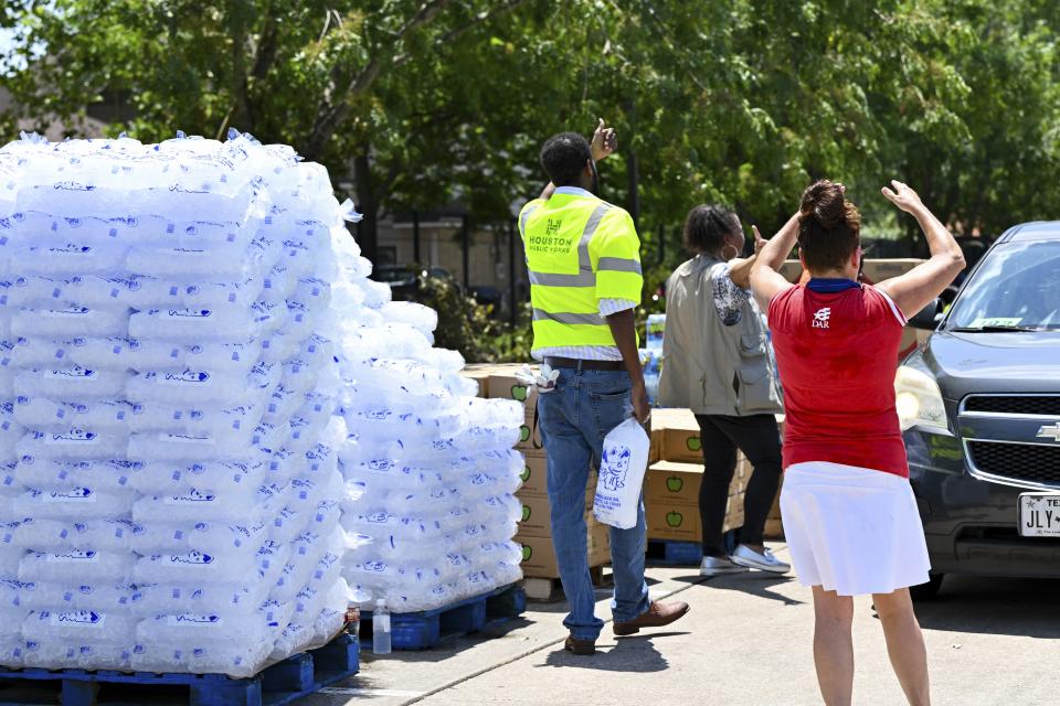 Volunteers help to hand out ice and supplies at Acres Homes cooling center in Houston, Wednesday, July 10, 2024. After Hurricane Beryl slammed into Texas, knocking out power to nearly 3 million homes and businesses. (AP Photo/Maria Lysaker)