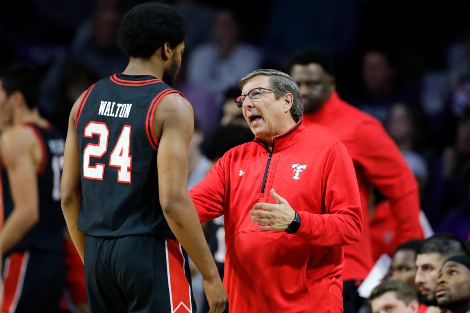 Texas Tech head coach Mark Adams, right, talks with Kerwin Walton (24) during the first half of an NCAA college basketball game against Kansas State, Saturday, Jan. 21, 2023, in Manhattan, Kan. (AP Photo/Colin E. Braley)