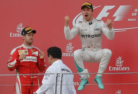 Formula One - Grand Prix of Europe - Baku, Azerbaijan - 19/6/16 - Mercedes Formula One driver Nico Rosberg (R) of Germany celebrates winning the race next to second placed Ferrari Formula One driver Sebastian Vettel of Germany. REUTERS/Maxim Shemetov