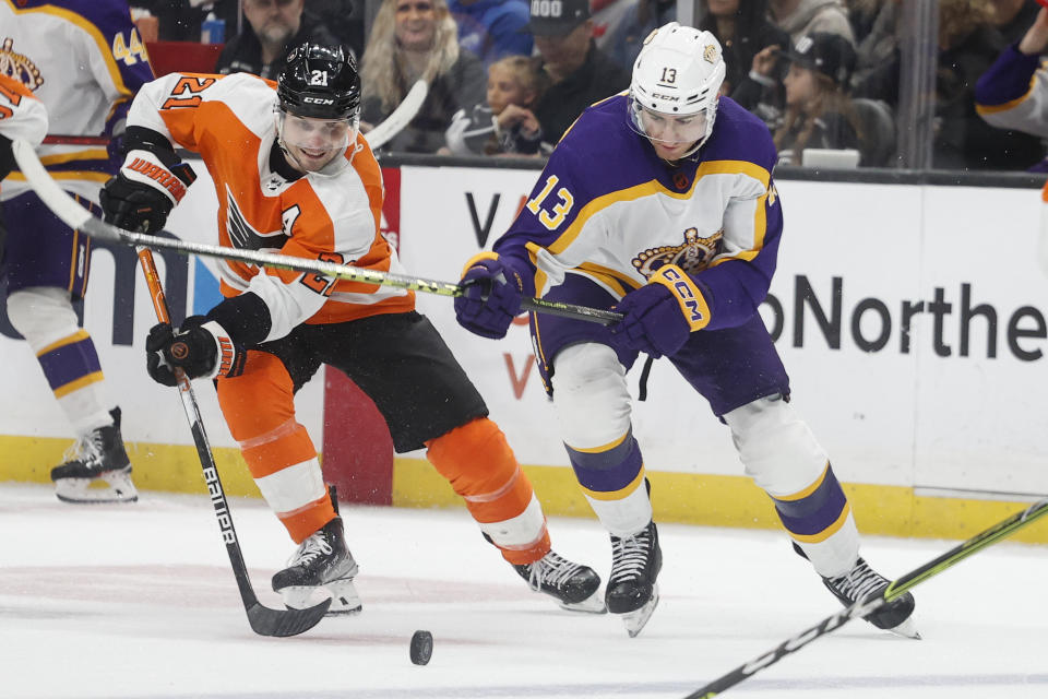 Philadelphia Flyers forward Scott Laughton, left, and Los Angeles Kings forward Gabriel Vilardi vie for the puck during the second period of an NHL hockey game Saturday, Dec. 31, 2022, in Los Angeles. (AP Photo/Ringo H.W. Chiu)