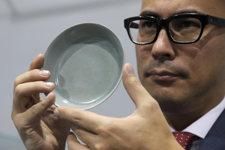 The brush washer fetched HK$294.3 million (£28 million) at the auction, setting a new world record price for Chinese ceramics. (AP Photo/Kin Cheung)