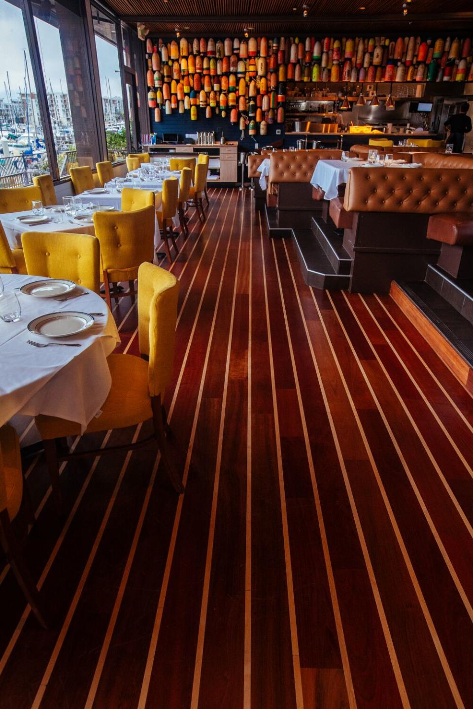 Boat buoys hang from a wall inside Dear Jane's, a seafood-focused restaurant in Marina del Rey.