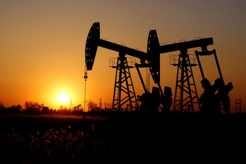 Pumpjacks are seen against the setting sun at the Daqing oil field in Heilongjiang province, China December 7, 2018. Picture taken December 7, 2018. REUTERS/Stringer