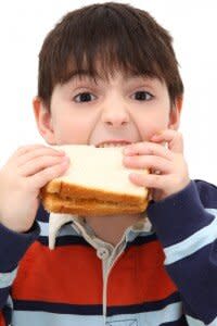 hungry boy eating sandwich