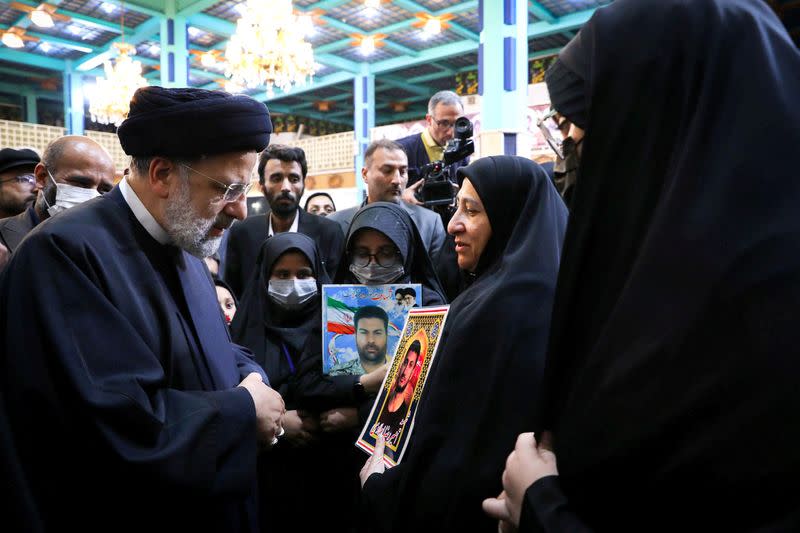 Iranian President Ebrahim Raisi meets with the families of security forces killed during Iran's protests, in Tehran