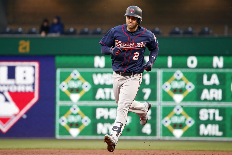 FILE - Minnesota Twins' Brian Dozier rounds second after hitting a solo home run off Pittsburgh Pirates starting pitcher Ivan Nova during the third inning of a baseball game in Pittsburgh, in this Wednesday, April 4, 2018, file photo. Former Minnesota second baseman Brian Dozier has retired after nine years in the major leagues and 167 career home runs, the Twins announced on Thursday, Feb. 18, 2021. (AP Photo/Gene J. Puskar, File)