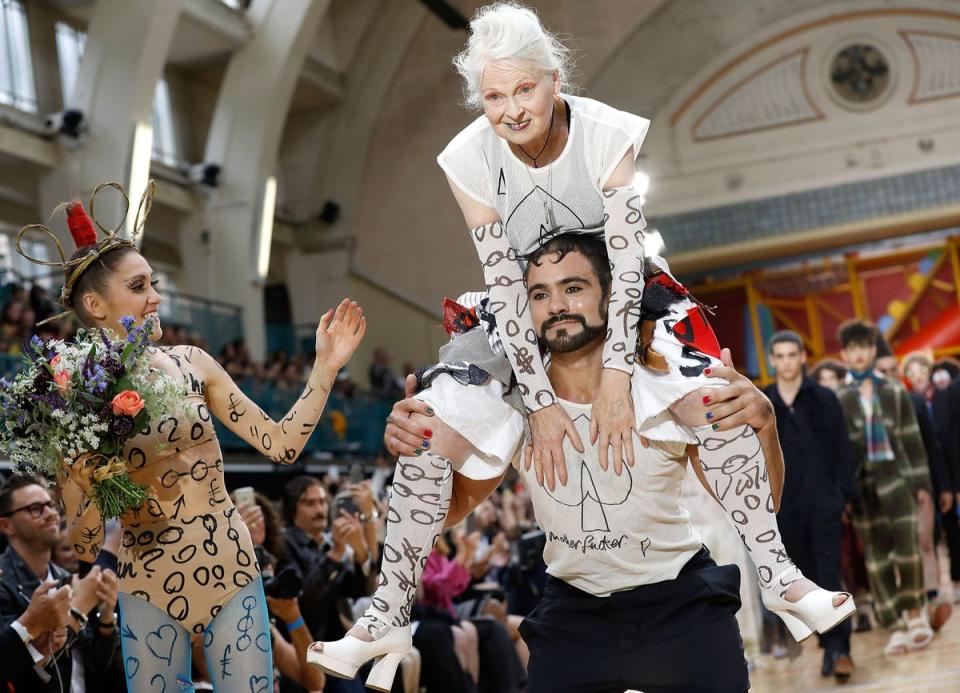 On top: Westwood gets a lift down the runway at Men’s London Fashion Week in June 2017 (Getty)