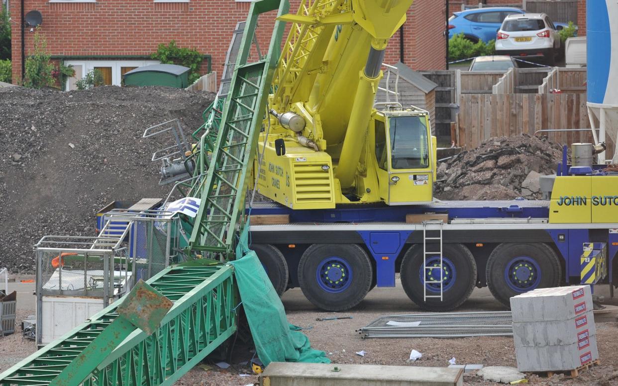 The scene where a crane has collapsed where a man has been air lifted to hospital and two others are injured - STEVE ALLEN