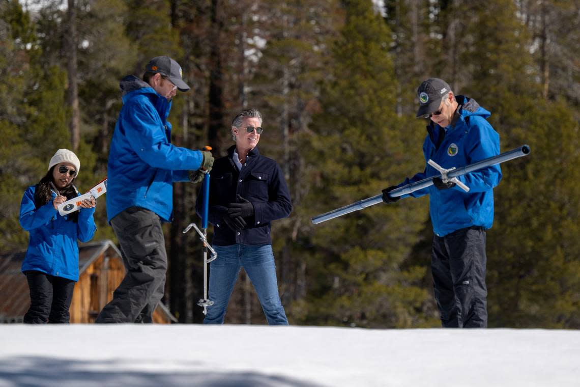 Gov. Gavin Newsom watches Andrew Reising of the Department of Water Resources, right, measure snow depth during the April snow survey, the last one of year, at Phillips Station in El Dorado County on Tuesday, April 2, 2024. The measurement of the April water content in the snowpack is 110% of normal and is a key indicator for future water supply. Paul Kitagaki Jr./pkitagaki@sacbee.com