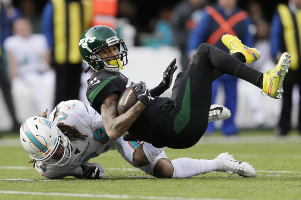 Miami Dolphins cornerback Ryan Lewis (24) tackles New York Jets wide receiver Robby Anderson (11). (AP Photo/Adam Hunger)