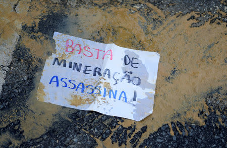 A paper that reads; "Enough of murderous mining!" is seen on a street during a protest against Brazilian mining company Vale SA in Belo Horizonte, Brazil January 31, 2019. REUTERS/Washington Alves