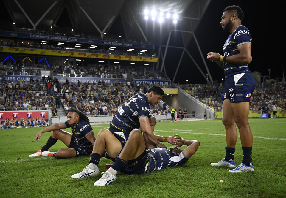 Cowboys players, pictured here looking on dejected after their NRL preliminary final loss to Parramatta.