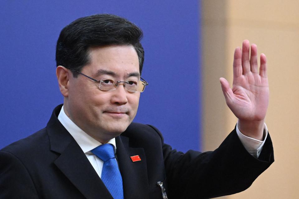 China's former Foreign Minister Qin Gang waves as he arrives for a press conference in Beijing on March 7, 2023. He was last seen in June.