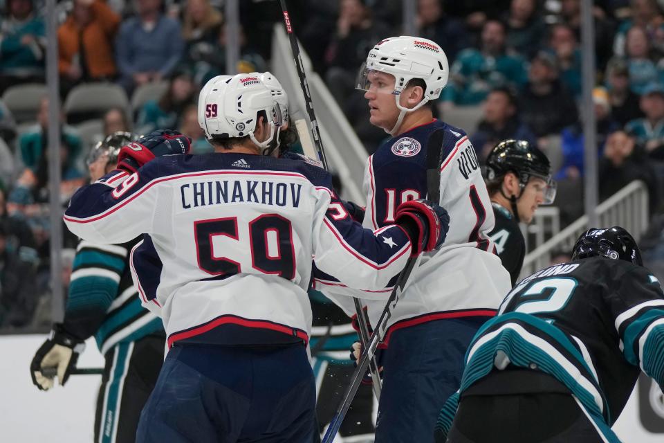 Columbus Blue Jackets left wing Dmitri Voronkov, middle right, is congratulated by right wing Yegor Chinakhov (59) after scoring against the San Jose Sharks during the second period of an NHL hockey game in San Jose, Calif., Saturday, Feb. 17, 2024. (AP Photo/Jeff Chiu)