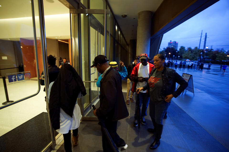 A Voting official waves people in as voting polls open at the Center for Civil and Human Rights, Atlanta, Georgia.