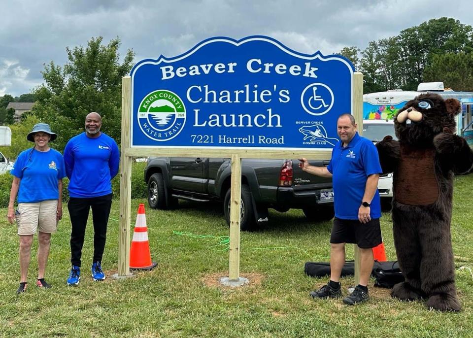 Knox County Commissioner Terry Hill and Knox County Director of Parks and Rec Joe Mack dedicate the launch at Roy Arthur Stormwater Park in Karns to Beaver Creek Kayak Club founder and President Charlie Austin while the Beaver cheers at the annual Beaver Creek Flotilla May 20, 2023.