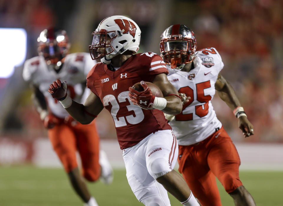 Wisconsin running back Jonathan Taylor runs for a touchdown as Western Kentucky linebacker Masai Whyte (25) give chase during the first half of an NCAA college football game Friday, Aug. 31, 2018, in Madison, Wis. (AP Photo/Andy Manis)