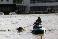 <p>A man uses a jet ski to help a cow swim across a flooded field to rescue after rainstorms caused flooding and landslides in Abbotsford, British Columbia, Canada November 16, 2021. REUTERS/Jesse Winter</p> 