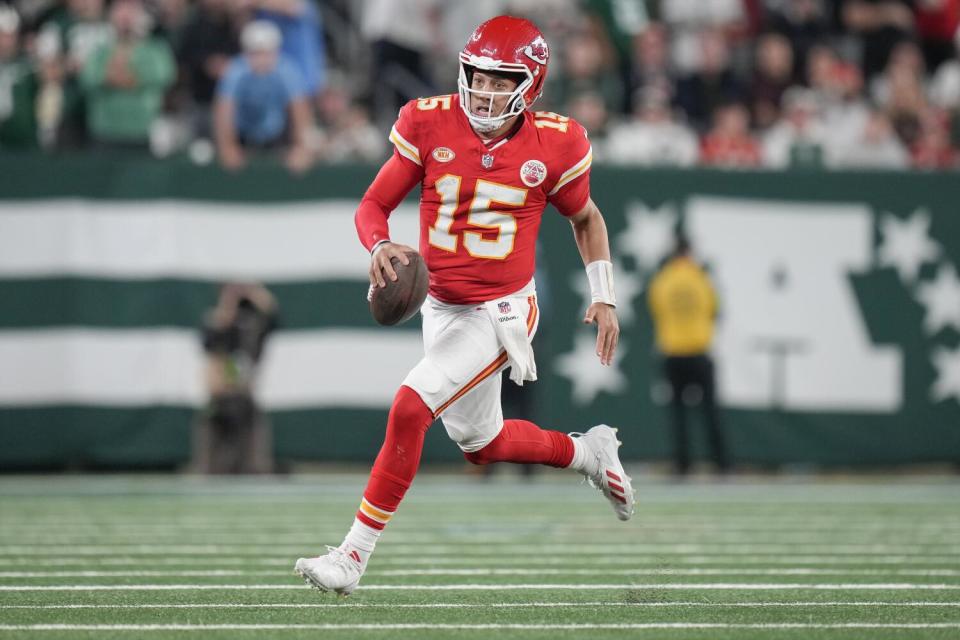 Kansas City Chiefs quarterback Patrick Mahomes runs with the ball.