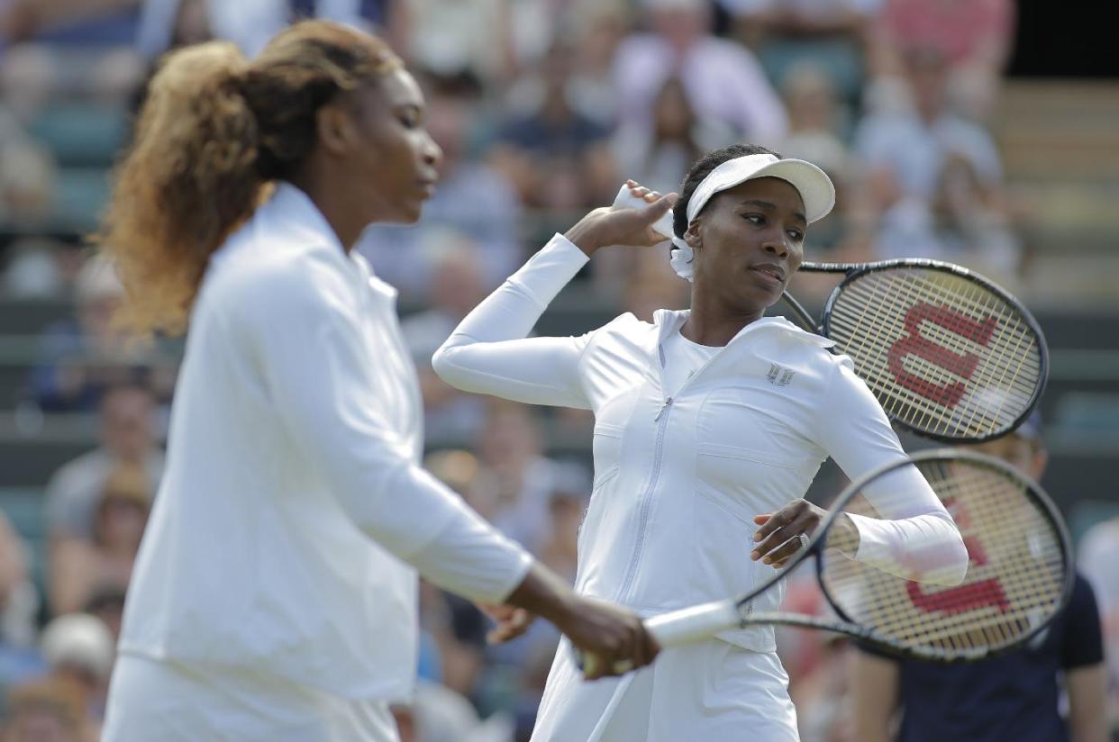 Serena Williams and Venus Williams at Wimbledon last month. (AP Photo/Pavel Golovkin)
