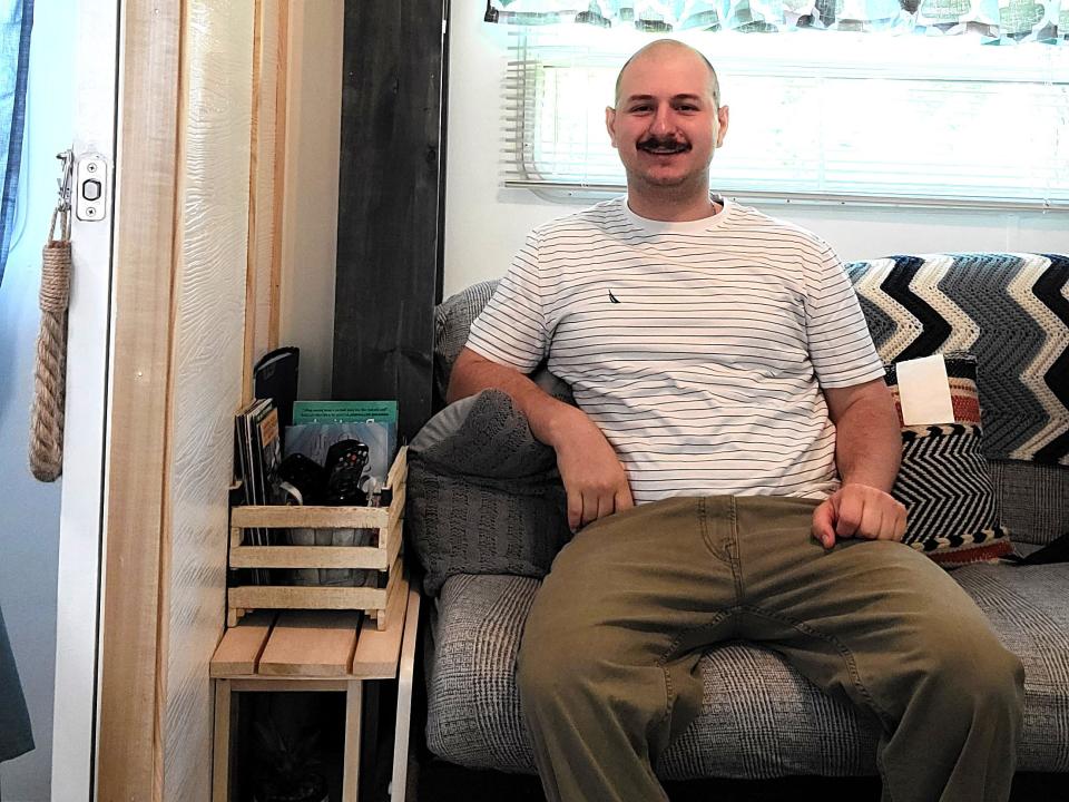 Lucien sitting on the couch in the RV.