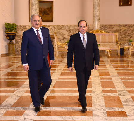 Libyan military commander Khalifa Haftar walks with Egyptian President Abdel Fattah al-Sisi at the Presidential Palace in Cairo, Egypt April 14, 2019 in this handout picture courtesy of the Egyptian Presidency. The Egyptian Presidency/Handout via REUTERS