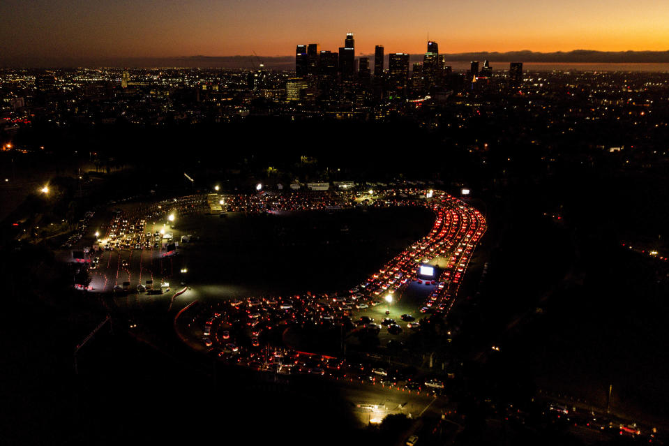 FILE - In this Nov 18, 2020, file aerial photo, motorists wait in long lines to take a coronavirus test in a parking lot at Dodger Stadium in Los Angeles. The Los Angeles County has announced a new stay-home order as coronavirus cases surge out of control in the nation's most populous county. The three-3 week order take effect Monday, Nov. 30, 2020. The order advises residents to stay home "as much as possible" and to wear a face covering when they go out. It bans people from gathering with people who aren't in their households, whether publicly or privately. (AP Photo/Ringo H.W. Chiu, File)