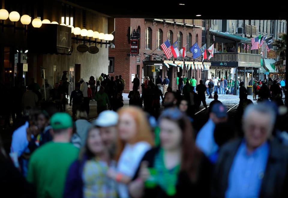 Crowds of revelers celebrate a previous St. Patrick’s Day along historic River Street in Savannah.