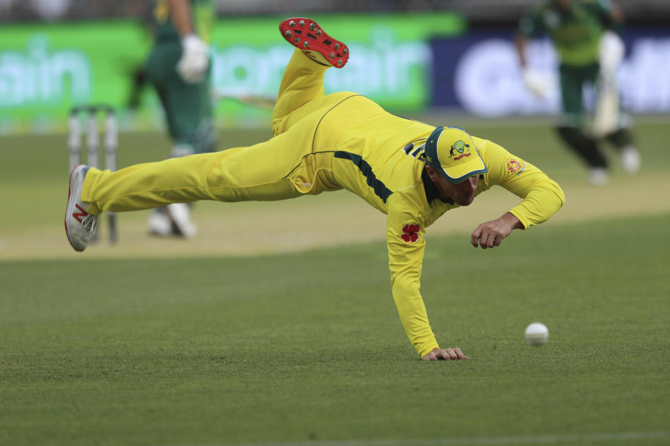 Australia's Aaron Finch dives for a ball from South Africa's Reeza Hendricks during their one-day international cricket match in Perth, Sunday, Nov. 4, 2018. (AP Photo/Trevor Collens)
