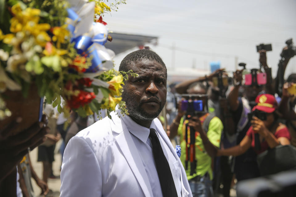 FILE - Jimmy Cherizier, alias Barbecue, a former police officer who heads a gang coalition known as "G9 Family and Allies, leads a march to demand justice for slain Haitian President Jovenel Moise in Lower Delmas, a district of Port-au- Prince, Haiti July 26, 2021. The United Nations Security Council is expected to vote Wednesday afternoon, Oct. 19, 2022, on a resolution that would demand an immediate end to violence and criminal activity in Haiti and impose sanctions on influential gang leader Cherizier.(AP Photo/Odelyn Joseph, File)