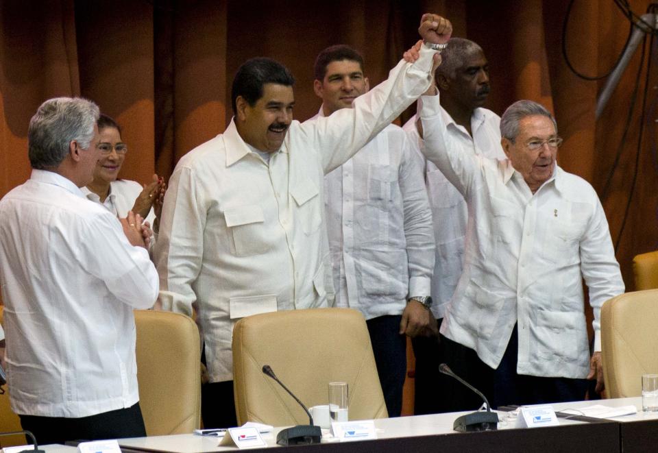 Cuba's President Raul Castro, center right, and Venezuela's President Nicolas Maduro raise their arms during the XV Political Council of the Bolivarian Alliance for the Americas group, ALBA, in Havana, Cuba, Monday, April 10, 2017. (AP Photo/Ramon Espinosa)