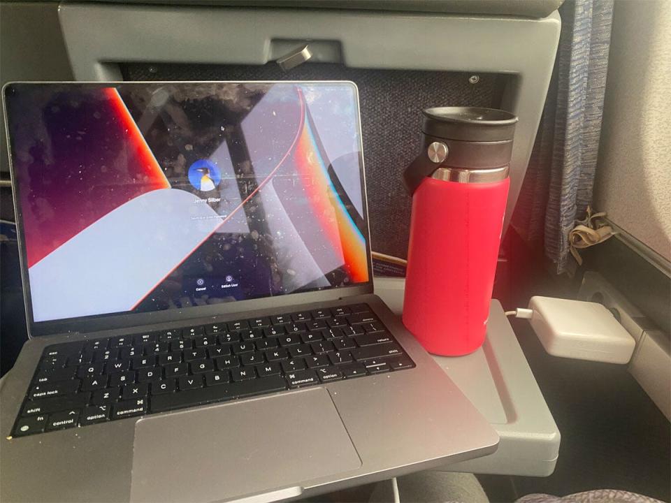 laptop and water bottle on amtrak tray