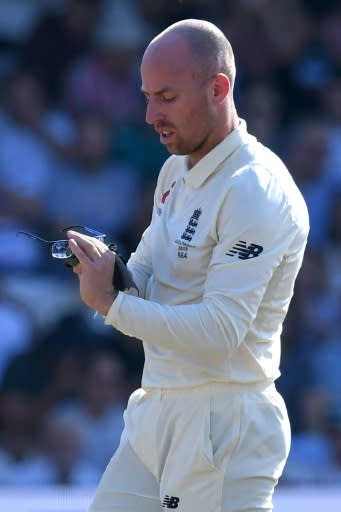 England's Jack Leach cleans his glasses during a break in play