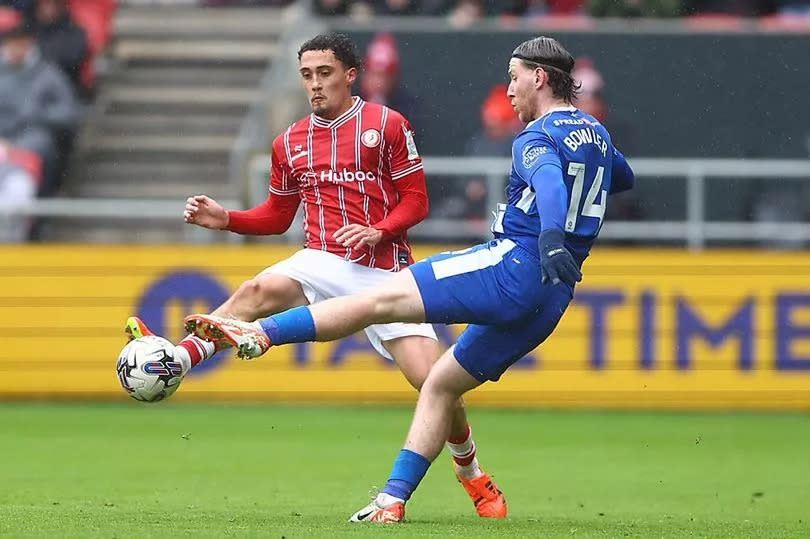 Haydon Roberts of Bristol City and Josh Bowler of Cardiff City in action