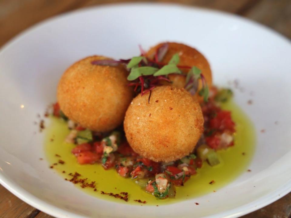 At Brick and Barrel Pub, yuca croquetas are stuffed with braised oxtail.