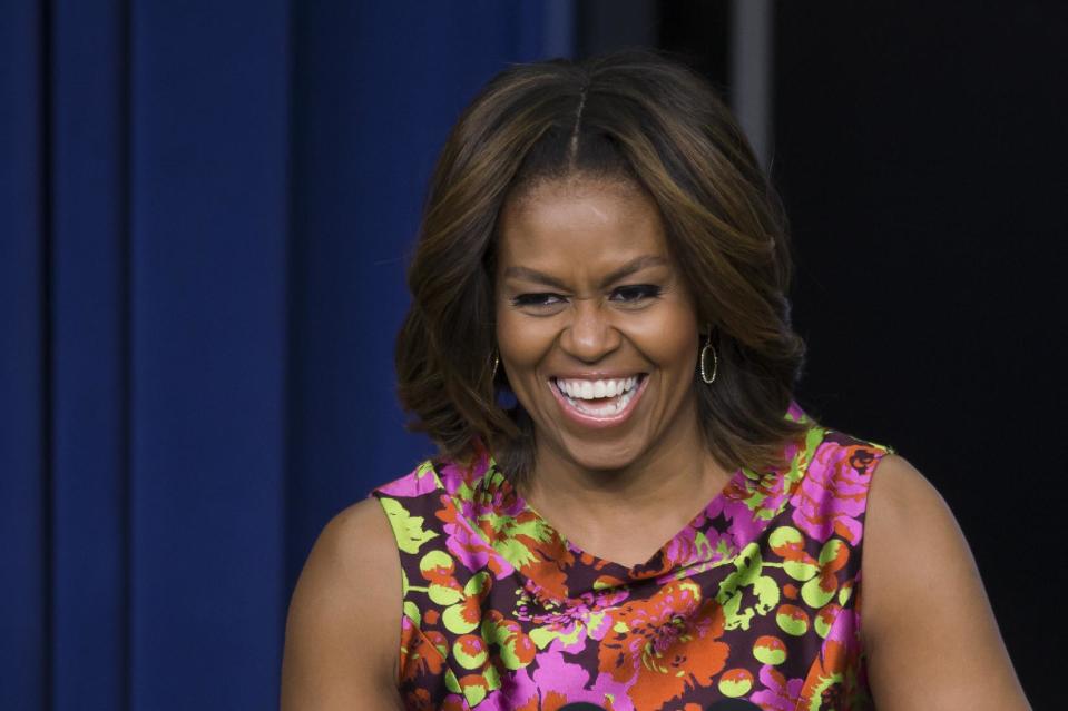 First lady Michelle Obama laughs as she speaks after a screening of the movie "The Trip to Bountiful" Monday, Feb. 24, 2014, in the South Court Auditorium on the White House complex in Washington. (AP Photo/ Evan Vucci)