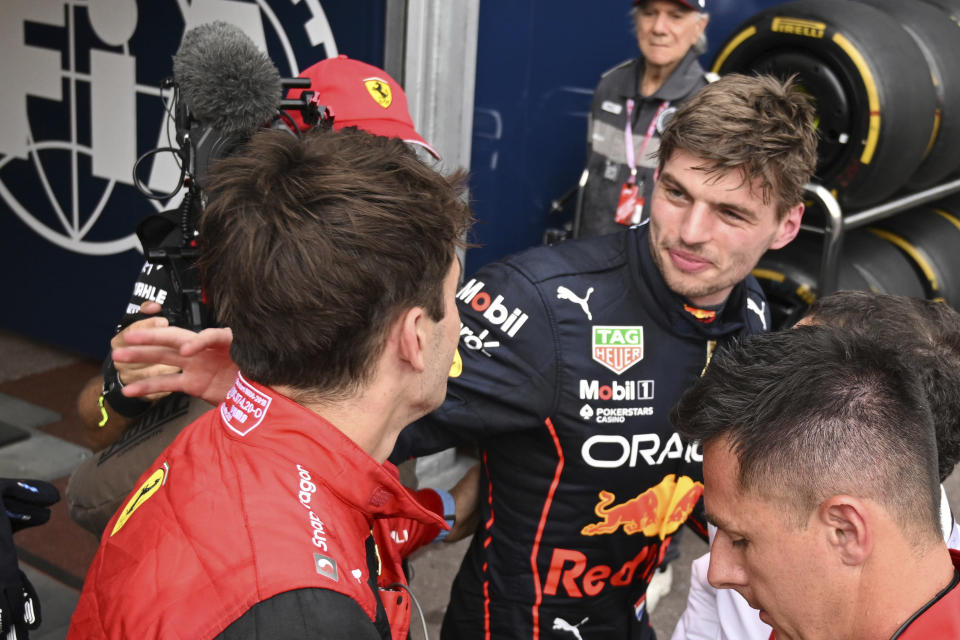 Ferrari driver Charles Leclerc of Monaco, left, is congratulated by Red Bull driver Max Verstappen of the Netherlands after setting the pole position in the qualifying session at the Monaco racetrack, in Monaco, Saturday, May 28, 2022. The Formula one race will be held on Sunday. (Pool Photo/Christian Bruna/Via AP)