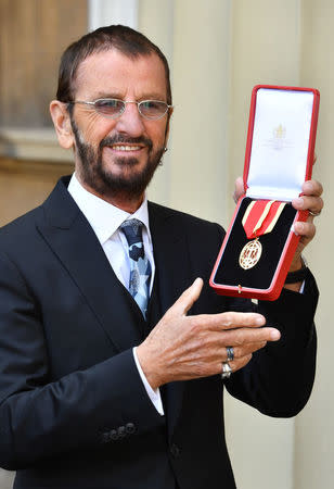 Ringo Starr, whose real name is Richard Starkey, poses after receiving his Knighthood at an Investiture ceremony at Buckingham palace in London, Britain, March 20, 2018. John Stillwell/Pool via Reuters