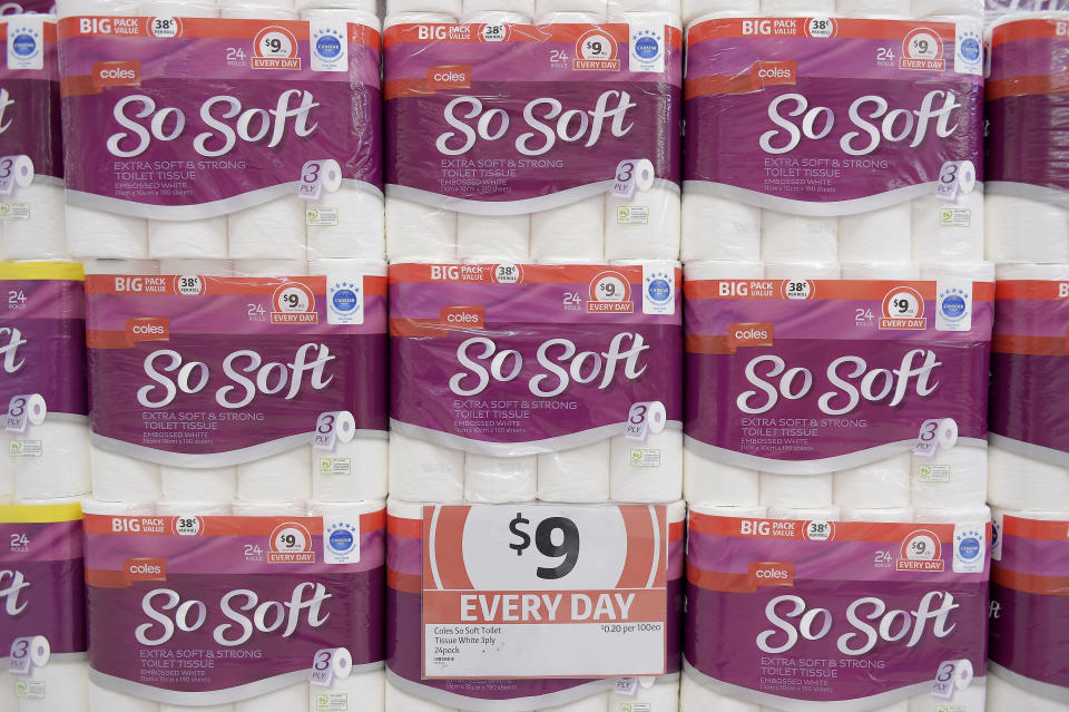 Coles toilet paper seen stacked up in the aisle. 