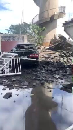 A damaged car and debris from the collapsed Nanfang'ao Bridge are seen after a typhoon hit Su'ao in Yilan county, Taiwan