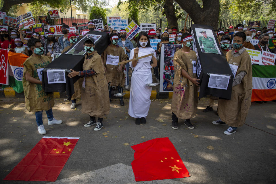 Chin refugees from Myanmar carry mock coffins of Commander in chief, Senior Gen. Min Aung Hlaing and Chinese President Xi Jinping during a protest against military coup in Myanmar, in New Delhi, India, Wednesday, March 3, 2021. (AP Photo/Altaf Qadri)