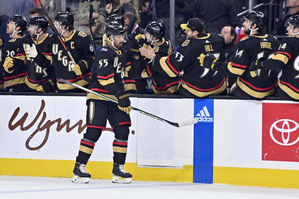 Vegas Golden Knights right wing Keegan Kolesar (55) celebrates at the bench after scoring a goal against the Nashville Predators during the first period of an NHL hockey game Saturday, Dec. 31, 2022, in Las Vegas. (AP Photo/David Becker)