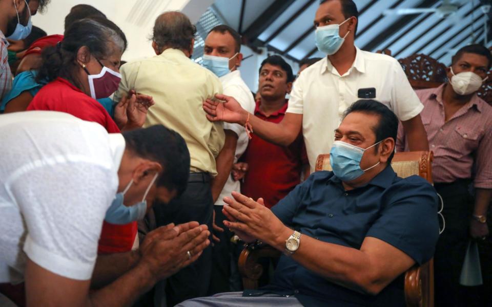 Sri Lankan Prime Minister elect Mahinda Rajapaksa greets people at his home - CHAMILA KARUNARATHNE/EPA-EFE/Shutterstock