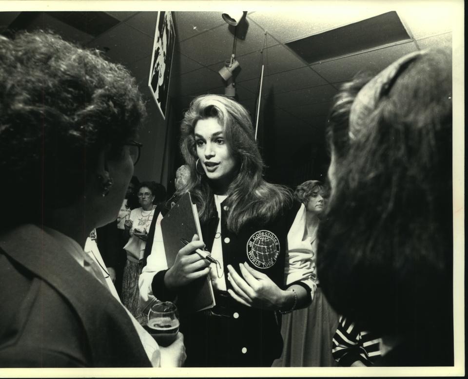 Supermodel Cindy Crawford chats with fans at Mayfair Mall's Boston Store, September 8, 1991. Crawford was helping to promote the JH Collectibles line of clothing. Asked if she and her man, actor Richard Gere, plan to marry, Crawford said, 'He hasn't asked yet.' And if he did? I'd probably say 'yes,