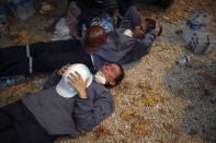 Turkish volunteers rest as they fight wildfires in Turgut village, near tourist resort of Marmaris, Mugla, Turkey, Wednesday, Aug. 4, 2021. As Turkish fire crews pressed ahead Tuesday with their weeklong battle against blazes tearing through forests and villages on the country's southern coast, President Recep Tayyip Erdogan's government faced increased criticism over its apparent poor response and inadequate preparedness for large-scale wildfires.(AP Photo/Emre Tazegul)