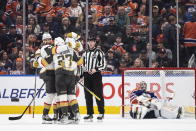 Vegas Golden Knights celebrate an overtime goal on Edmonton Oilers goalie Stuart Skinner (74) during the an NHL hockey game Saturday, March 25, 2023, in Edmonton, Alberta. (Jason Franson/The Canadian Press via AP)